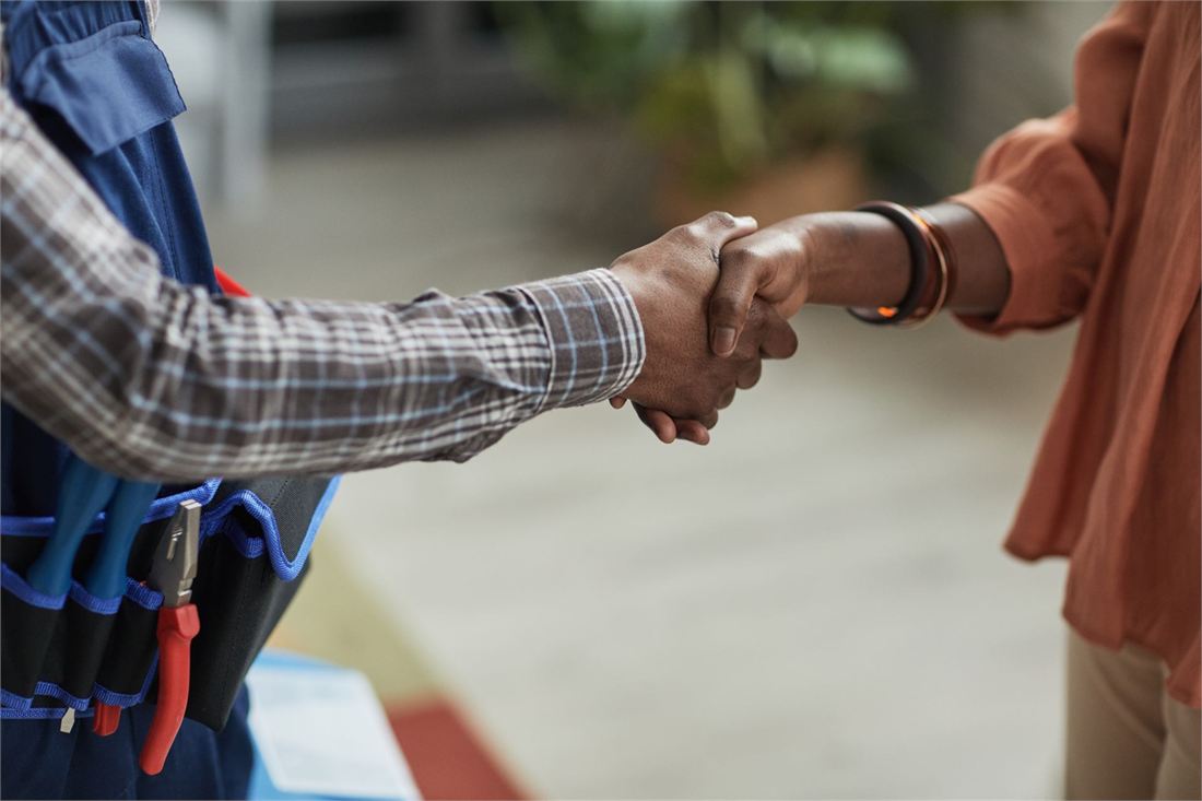 A tradesperson shaking hands with a client